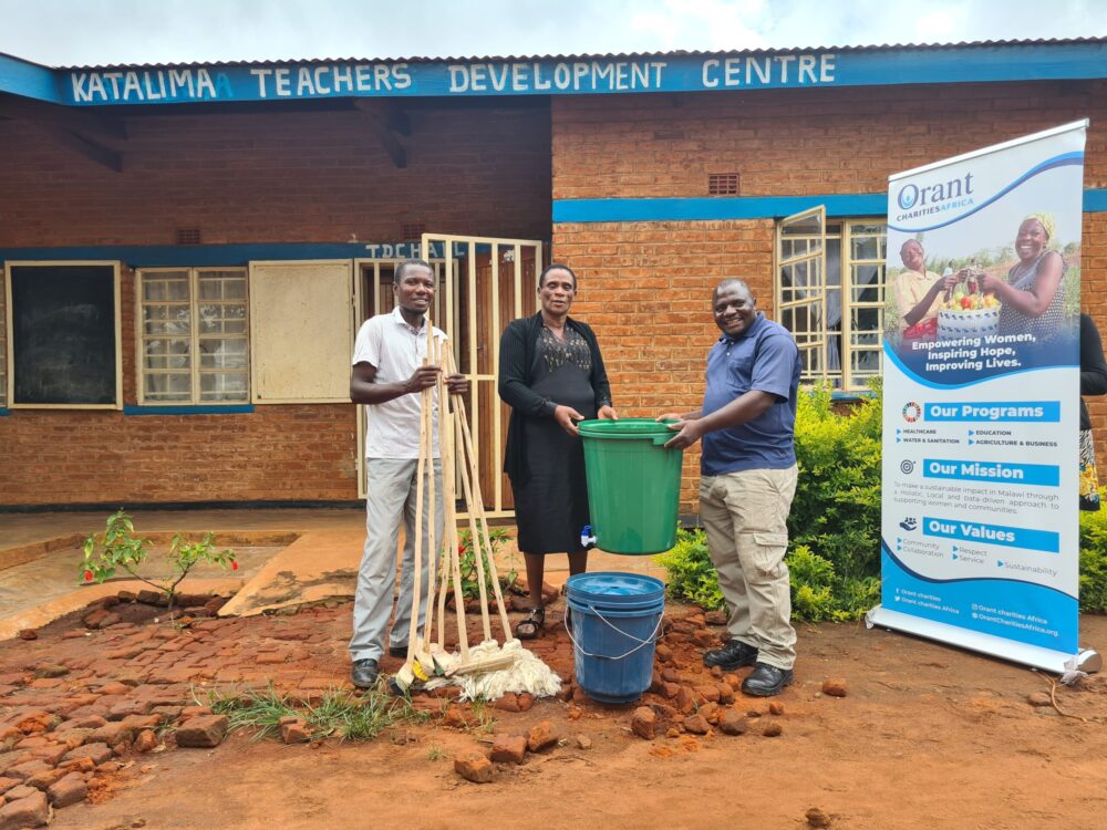 Orant staff and school administrators with some of the new sanitation supplies