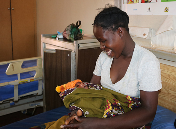 A new mother holds her baby at Kasese Health Center in Malawi