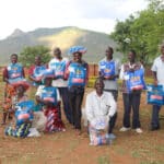 The members of Mwayiwathu Cohort 1 Farmers Club hoist bags of seed and celebrate their graduation!